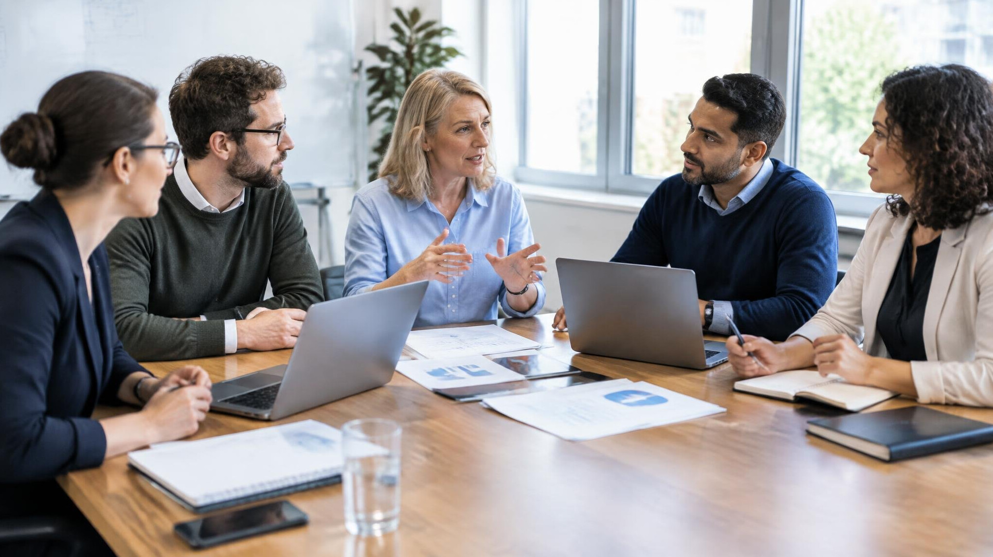 Diverse research team discussing findings around a table